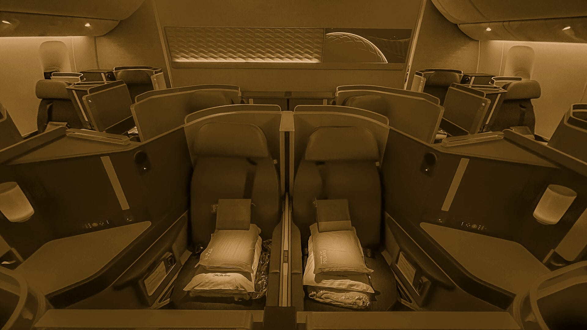 A business class cabin in deep blue night lighting